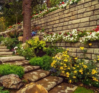 Retaining walls making a multi-level flower beds with stone stairs